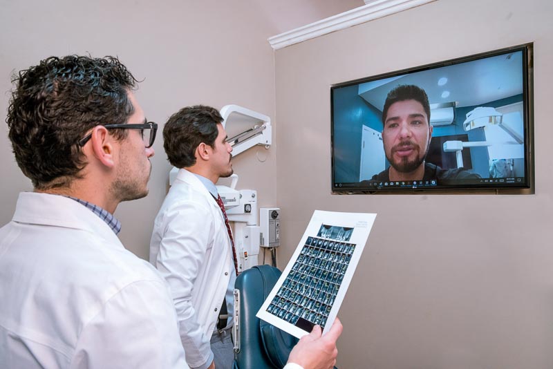 Dr. Nestor and Dr. Diego are speaking with Dr. Galvez in a video conference. Dr. Diego is looking at x-rays and they are listening to Dr. Galvez.
