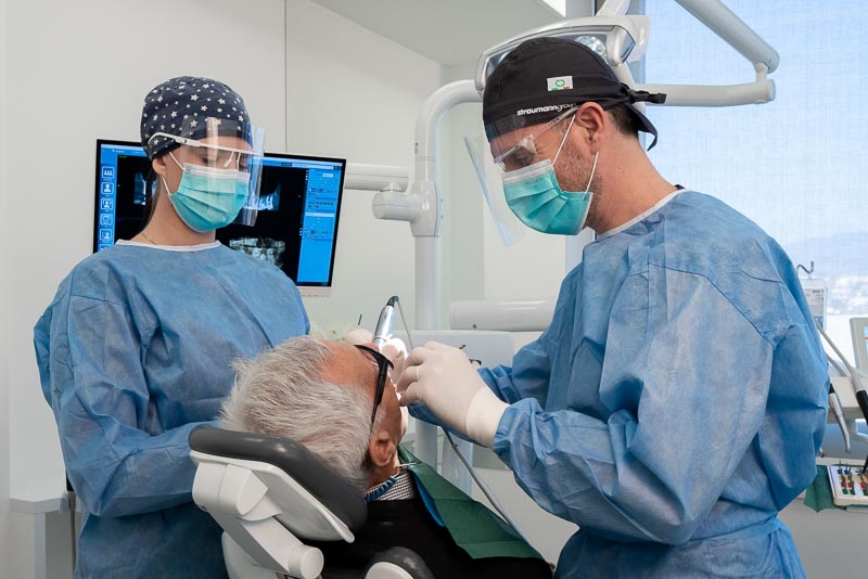 Dr. Bago, a dentist with SOTA Dental in Zagreb, Croatia, performs dental implant surgery on a male patient.