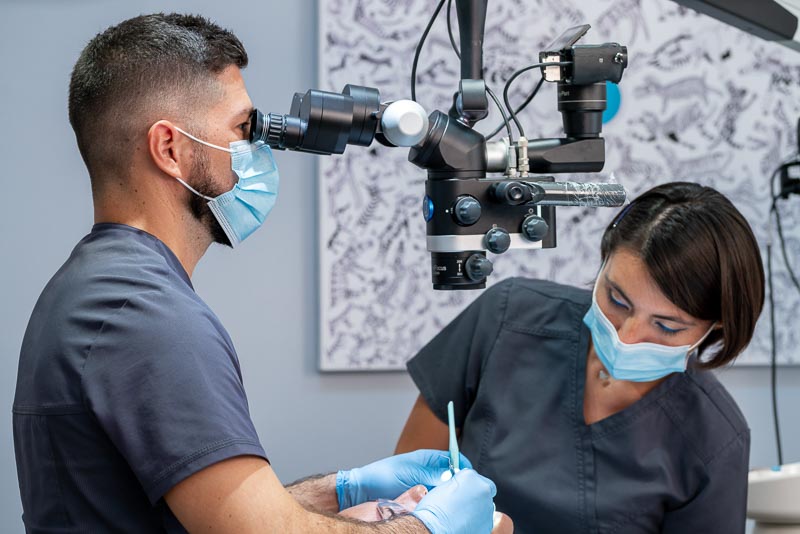 Dr. Galvez from SOTA Dental Cancun performs a root canal treatment using a microscope.