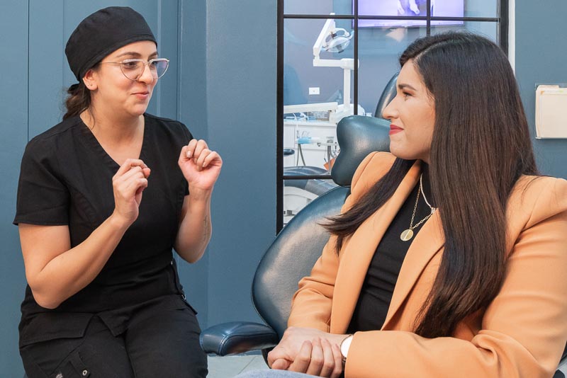 Dr. Karen, dentist in Los Algodones at SOTA Dental, discussing dental implant & all-on-4 cost in Mexico with a female patient.