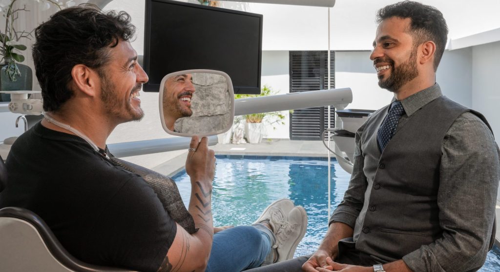 Dr. Miller with a happy All-on-4 patient - view SOTA Dental Mexico's affordable price list.