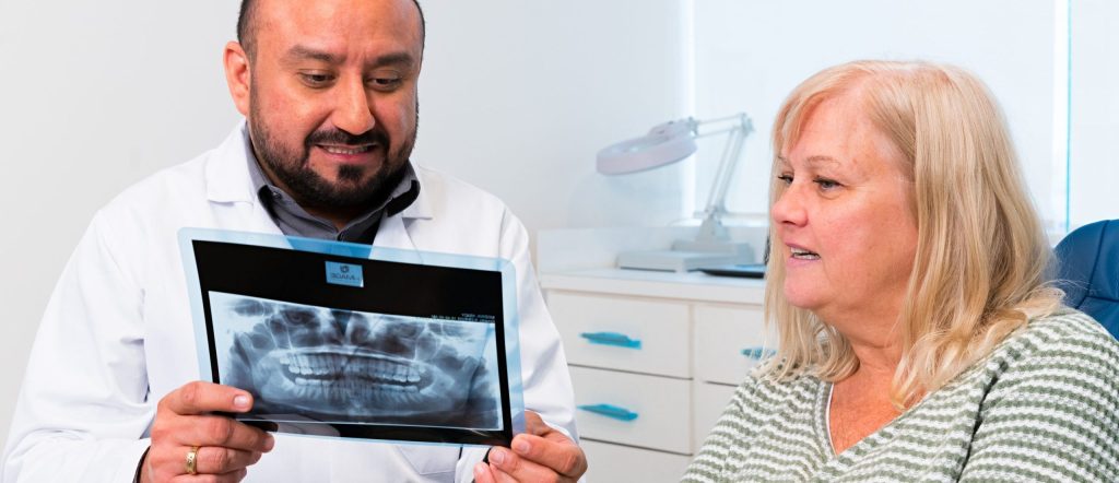 Dr. Trejo offering support to an All-on-4 patient during their recovery journey.